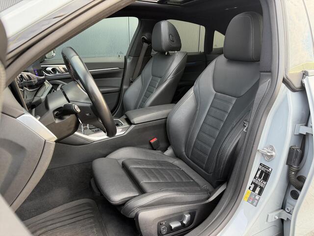 BMW i4 M50 High Executive 84 kWh 19"/SOH 99%/Schuif-kanteldak/Trekhaak/Leder + memory/Stoel + stuurverwarming/Harman Kardon/Dodehoek/Adaptieve cruise/Keyless/360 camera