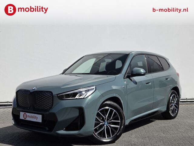 BMW iX1 eDrive20 67 kWh M-Sport SOH 99% Driving Assist. Plus | Sportstoelen | Park Assist | Leer | Adaptive Cruise Control | DAB | NL Auto! | Achteruitrijcamera