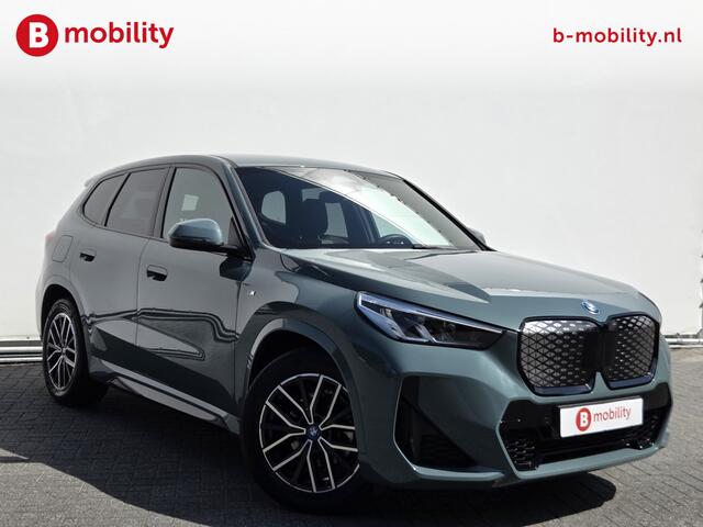 BMW iX1 eDrive20 67 kWh M-Sport SOH 99% Driving Assist. Plus | Sportstoelen | Park Assist | Leer | Adaptive Cruise Control | DAB | NL Auto! | Achteruitrijcamera