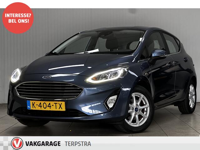 Ford FIESTA 1.0 EcoBoost Titanium/ 15'' LMV/ LED Koplampen/ DAB+/ Lane-Assist./ Clima/ Cruise/ Elek. pakket/ Isofix/ Bluetooth/ Multi. LEDER. Stuur/ Mistl./ PDC/ Chroom/ LED Dagrijverl.