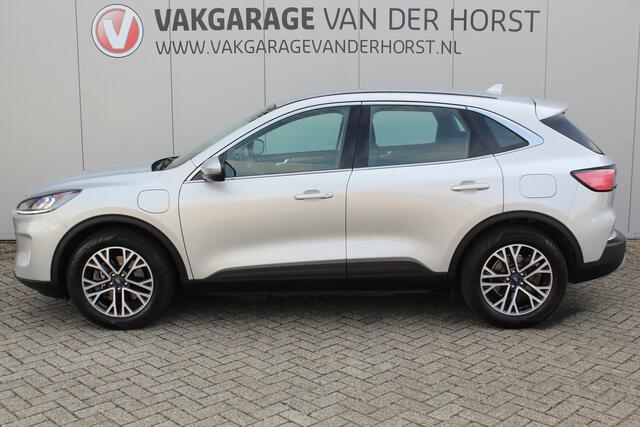 Ford KUGA 2.5-225pk PHEV Titanium. Hybride rijden voor een reëel bedrag ! Autm. airco dual, stoel-, stuur-, achterbank- en voorraamverw., navigatie, telefoonvoorb., trekhaak, metallic lak, LM wielen+ AllSeason banden etc.