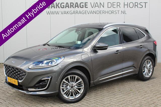 Ford KUGA 2.5-225pk PHEV Vignale. In uiterst nette staat verkerende Ford Kuga in de zeer chique Vignale uitvoering met slechts 23.000km ! Adapt. cruise cntrl, side- en lane assist, trekhaak, head-up display, B&O soundsyst., lederen int., stuur-, stoel-, achterbank- en voorraamverw. etc.