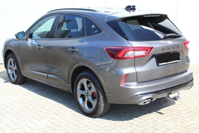 Ford KUGA 2.5-243pk PHEV ST-Line X. Febr. 2026, slechts 9.800km ! Autm. airco dual, elektr. panodak, elektr. trekhaak, elektr. achterklep, leer/alcantara, klep, LED verl., navigatie, telefoonvoorb., stoel-, stuur-, voorraam- en achterbankverw., side- en lan