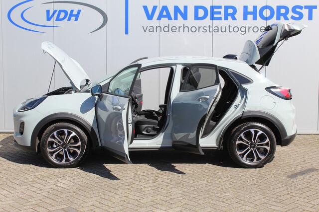 Ford PUMA 1.0-125pk EcoBoost Mild-Hybrid Titanium. Nieuw Model ! Van ¤ 35.920,- voor ¤ 27.880,-: ruim ¤. 8.000,- beneden nieuwprijs. Slechts 9.000km ! Fabrieksgarantie t/m 14-10-2028 ! Lane- en side assist, Navigatie, Telefoonvoorb., Stoel-, stuur- en voorraamverwa