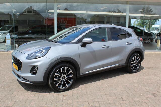 Ford PUMA 1.0-125pk EcoBoost Mild-Hybrid Titanium X. Garantie t/m 07-03-2028 ! Slechts 7.400km ! Cruise cntrl, climate cntrl, stoel-, stuur- en voorraamverw., draadloos opladen telefoon, trekhaak afneembaar, navigatie, telefoonvoorb., LM wielen, B&O soundsyst., digitaal dashboard etc.