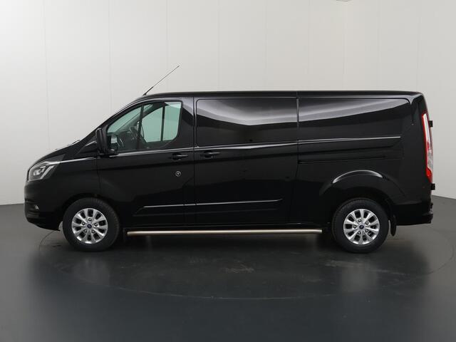 Ford TRANSIT CUSTOM 300 2.0 TDCI | L2 H1 | LIMITED | DUBBEL CABINE | AUT. | LEDEREN BEKLEDING | CAMERA | ADAPTIEVE CRUISE | STOELVERWARMING | NAVIGATIE | BI-XENON | 2X ZIJSCHUIFDEUR | AGATE BLACK METALLIC