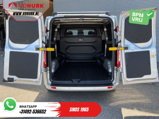Ford TRANSIT CUSTOM 2.0 TDCI 130 pk Aut. DC Dubbel Cabine 2xSchuifdeur/ NL Auto/ Carplay/ Leder/ Stoelverw./ Navi/ Cruise/ Camera/ Airco/ Dakdragers/ 16"LMV/ PDC/ Sidesteps