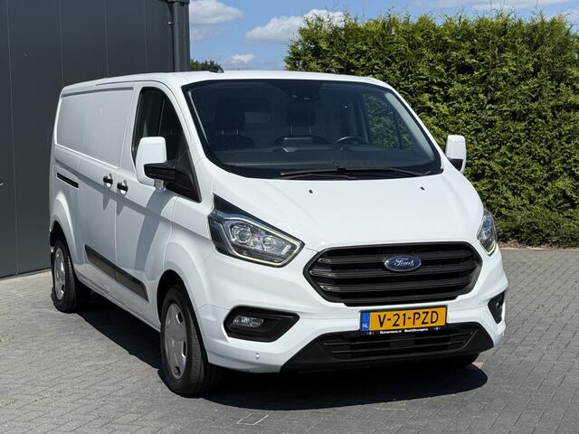 Ford TRANSIT CUSTOM 2.0 TDCI 130 PK / L2H1 / AUTOMAAT / TREKHAAK / AIRCO / CRUISE / CAMERA / 3-ZITS / LED / STOEL -EN VOORRUIT VERWARMING