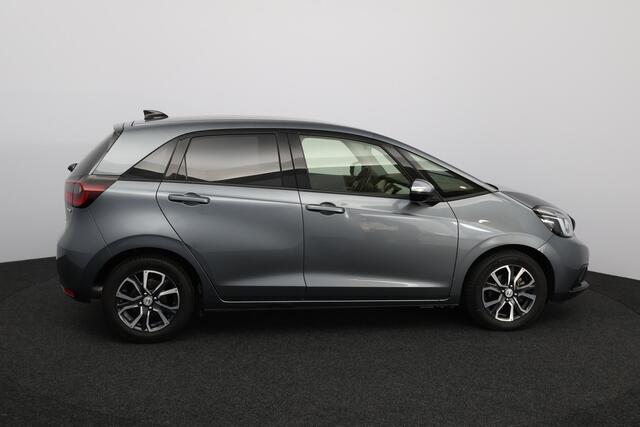 Honda JAZZ 1.5 e:HEV Executive/ LED Koplampen/ Camera/ Apple + Android/ DAB+/ Stoelverw./ Lane-Assist./ Adaptive Cruise/ Dode-Hoek DET./ Keyless/ Navi/ Multi. LEDER. Stuur/ PDC V+A/ Extra getint glas.