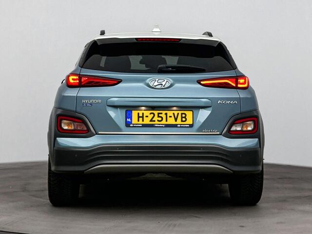 Hyundai Kona EV Premium 64 kWh | Stoelverwarming & verkoeling | Achteruitrij camera | Navigatie | Adaptive cruise | Side skirts | All season banden |