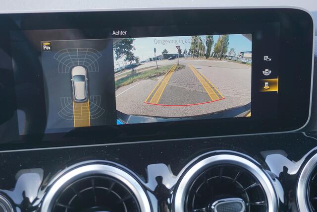 Mercedes-Benz B-KLASSE 180 Business Solution AMG l Trekhaak l MBUX l Stoelverwarming l Virtual Cockpit l Smartphone Integratie l Spiegel pakket l LED High Performance l Airconditioning THERMOTRONIC l Night pakket l Licht en zicht pakket l Tempomaat l Electrisch bedienbare achterklep l