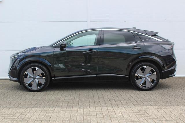 Nissan Ariya Evolve 87 kWh / 20" LM velgen / Stoelverwarming voor en achter / Automatische airco / Apple Carplay & Android Auto / Bluetooth telefoonvoorbereiding / Cruise control adaptief / DAB / Elektrisch glazen panorama-dak / Privacy glass / Stuurwiel verwarmd / Ro