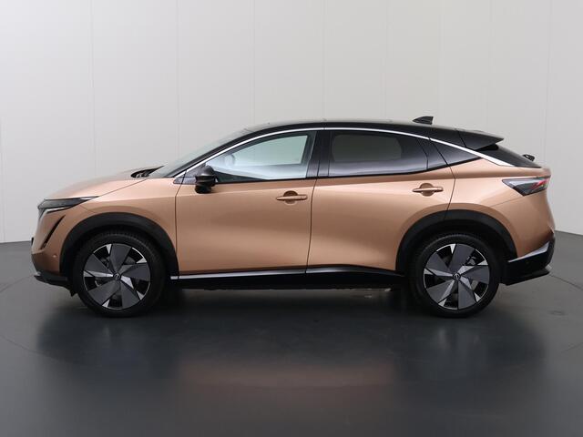 Nissan Ariya Trend Plus 91 kWh | SOH 99% | Trekhaak | Elektrisch verstelbare stoelen + Geheugen | BOSE audio | Stoelverwarming voor + achter | Navigatie | 360 Camera | DAB | Apple CarPlay/Android Auto | Stuurverwarming | Panoramadak | HUD | Adaptieve Cruise Control |