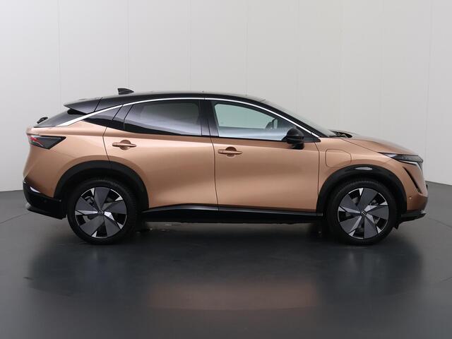 Nissan Ariya Trend Plus 91 kWh | SOH 99% | Trekhaak | Elektrisch verstelbare stoelen + Geheugen | BOSE audio | Stoelverwarming voor + achter | Navigatie | 360 Camera | DAB | Apple CarPlay/Android Auto | Stuurverwarming | Panoramadak | HUD | Adaptieve Cruise Control |