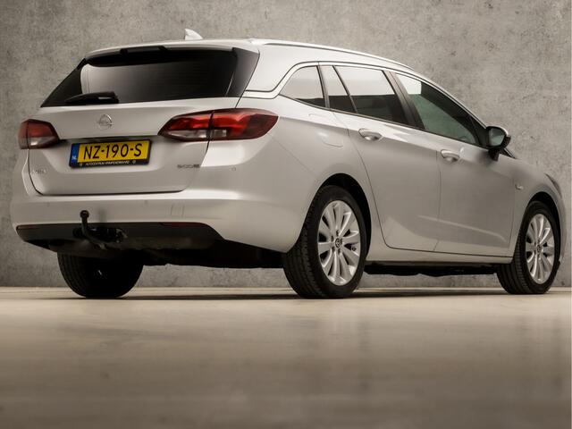 Opel ASTRA Sports Tourer 1.0 Sport (APPLE CARPLAY, GROOT NAVI, GETINT GLAS, TREKHAAK, PARKEERSENSOREN, SPORTSTOELEN, CRUISE, LM VELGEN, NIEUWE APK, NIEUWSTAAT)