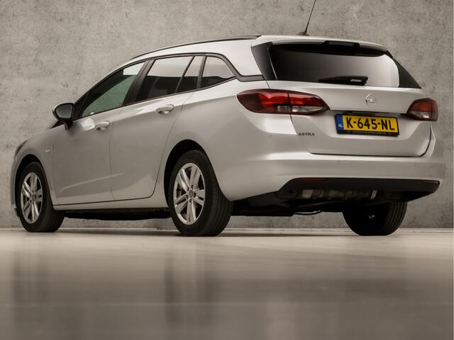 Opel ASTRA Sports Tourer 1.4 Sport 146Pk Automaat (APPLE CARPLAY, NAVIGATIE, CLIMATE, CAMERA, GETINT GLAS, SPORTSTOELEN, LM VELGEN, PARKEERSENSOREN, CRUISE, NIEUWSTAAT)