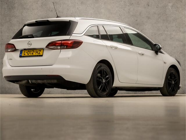 Opel ASTRA Sports Tourer 1.2 Elegance (APPLE CARPLAY, NAVIGATIE, CLIMATE, CAMERA, ADAPTIVE CRUISE, LEDER, SPORTSTOELEN, GETINT GLAS, LM VELGEN, NIEUWSTAAT)