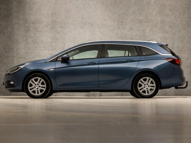 Opel ASTRA Sports Tourer 1.4 Sport 150Pk (APPLE CARPLAY, GROOT NAVI, CLIMATE, STUUR/STOELVERWARMING, SPORTSTOELEN, CAMERA, TREKHAAK, PARKEERSENSOREN, NIEUWSTAAT)