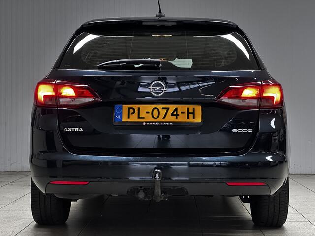 Opel ASTRA Sports Tourer 1.0 Online Edition/ Trekhaak/ Apple + Android/ DAB+/ Navi/ Airco/ Cruise/ Elek. pakket/ Isofix/ Bluetooth/ Armsteun/ Multi. LEDER. Stuur/ PDC V+a/ Dakrails/ LED Dagrijverl.