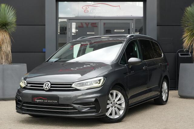 Volkswagen TOURAN 1.8 TSI Highline Business R 7p | 180pk | Pano | ACC | Camera | Volkswagen Touran 1.8 TSI Highline Business R 7P met 1.8 viercilinder benzinemotor en 7-traps DSG automaat, goed voor 179 PK. Zeer compleet uitgevoerd met panoramadak, achteruitrijcamera, ada
