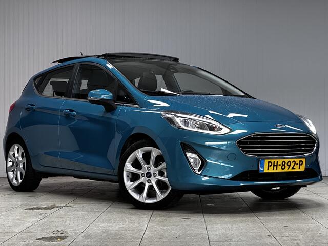 Ford FIESTA 1.0 EcoBoost Titanium/ DEALER ONDERHOUDEN!/ B&O/ Camera/ 17'' LMV/ Keyless/ Lane-Assist./ Panorama-Dak/ PDC V+A/ Chroom/ Apple + Android/ DAB+/ Navi/ Clima/ Cruise/ Multi. LEDER. Stuur/ Mistl.