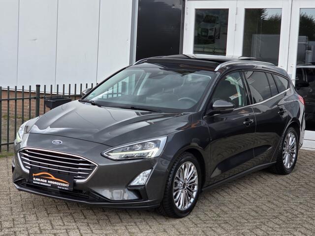 Ford FOCUS Wagon 1.0 EcoBoost Titanium Business PANORAMADAK|NAVIGATIE|CRUISE CONTROL|CAMERA|KEY LESSGO|BANG&OLUFSEN| MUZIEK|PDC VOOR+ACHTER|GETINT GLAS|ELEKTRISCHE KLEP|17 INCH Maandag tot Vrijdag geopend van 09.00 tot 20.00 uur geopend en Zaterdag van 09.00 tot 18.