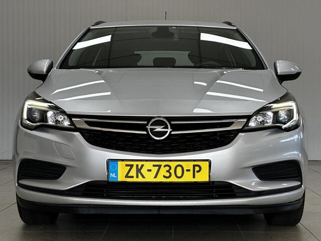 Opel ASTRA Sports Tourer 1.0 Turbo Business/ Apple + Android/ DAB+/ Navi/ Airco/ Cruise/ Elek. pakket/ Isofix/ Bluetooth/ Armsteun/ Multi. LEDER. Stuur/ PDC Achter.