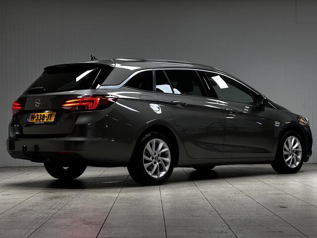 Opel ASTRA Sports Tourer 1.2 Elegance/ Trekhaak!/ LED Koplampen/ Virtual Cockpit/ Dodehoekdetectie/ Camera/ Zwarte Hemel/ Grootlichtass./ Keyless/ DAB+/ Apple+Android/ Clima/ Navi/ Cruise/ Bluetooth/ Multi.LEDER.Stuur/ Elek.Pakket
